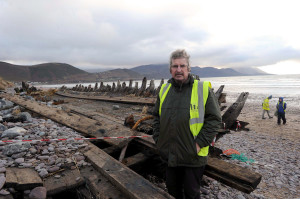 Laurence Dunne pictured with the recently unveiled wreck of 'The Sunbeam' on Rossbeigh Beach. Photo By : Domnick Walsh / Eye Focus LTD ¬© 