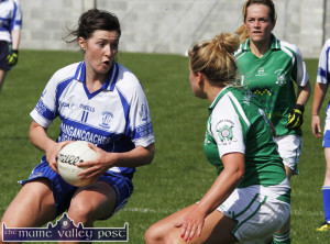 Desmonds centre-forward and captain, Lorraine Scanlon looks for an option as Na Gaeil full-back, Deirdre Kearney challenges her with wing-back, Kim Enright arriving during the Ladies County Intermediate Football Championship final in Ballymacelligott on Sunday afternoon. ©Photograph: John Reidy