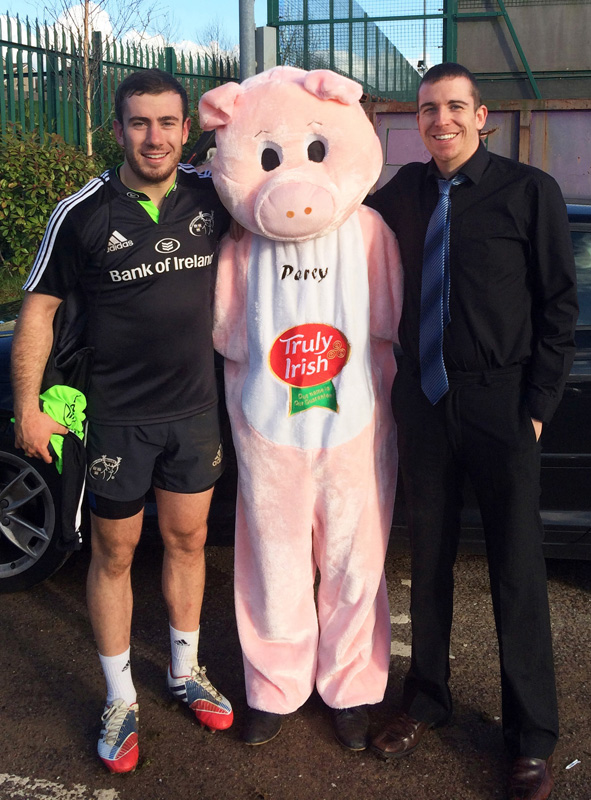 Munster Rugby star and Currow native, J.J.Hanrahan pictured with Truly Irish co-director, Shane McAuliffe and 'Percy' the Truly Irish Pig at the announcement of details of the Munster V Sale Sharks jersey logo competition. Pic Courtesy of Truly Irish.