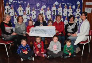 Pupils and teachers at Muire Gan Smál National School, Castleisland handing over the proceeds of their Christmas jumper day to representatives of the local branch of the Society of St. Vincent de Paul. Front: Alex Danowski, Maria Greaney, Shinora Riordan-Deery and Tadhg Nolan.  Seated from left: Mary Frances O'Shea and Martha O'Mahony, teachers; Shauna Griffin, Maura Browne, acting principal; Báithín O'Mahony, Helen O'Donoghue, St. Vincent de Paul; Marie Brosnan, former principal and Liz Galwey, St. Vincent de Paul. ©Photograph: John Reidy