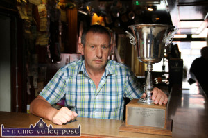 John Cronin pictured in Kate Pats' Bar with the Con Carey Memorial Cup which was donated to Brosna GAA Club by Brosna Town composer, Danny Hannon. The cup will be played for by teams from. Brosna and Rockchapel in a rare cross-border encounter. ©Photograph:  John Reidy