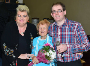 Norrie Lenihan (93) being presented with a bouquet of flowers by entertainer 'Big Maggie' and West Limerick FM presenter, Benny Thade McCarthy at the launch of the season in Abbeyfeale last week. 